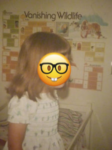 Photo of me at about age 4 with environmentalist posters behind me.