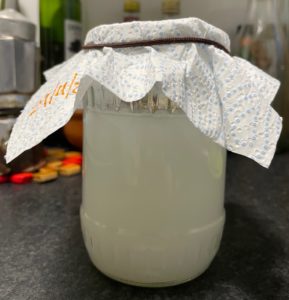 A glass jar containing rice wash to capture my LAB.