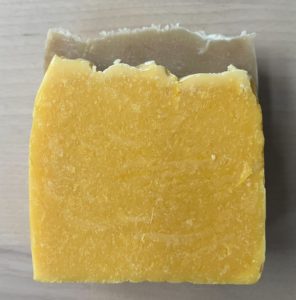 Photo of two pieces of soap, one beige and one orange. 