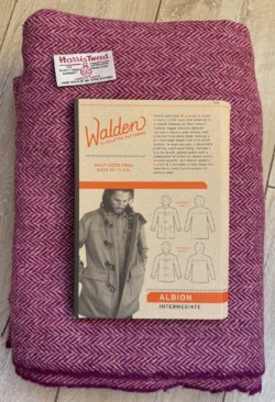 Photo of some purple herringbone Harris Tweed and a duffle coat pattern.