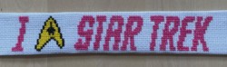 Cross stitch bookmark saying I "heart" Star Trek, where heart is actually the Star Trek logo.