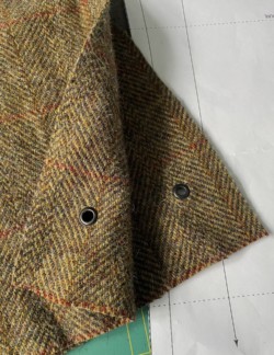 Photo of some Harris Tweed fabric with grommets.