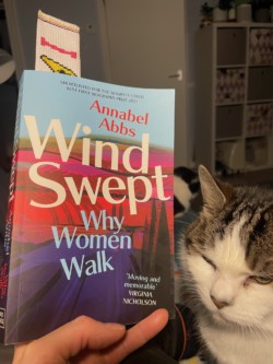 Photo of the book 'Windswept' by Annabel Abbs and my two cats.